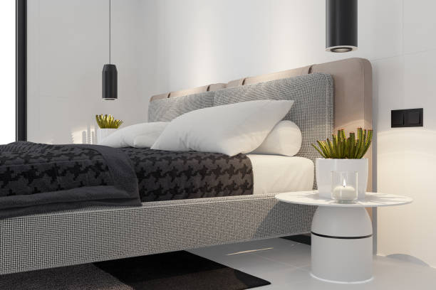 A sleek and stylish master bedroom featuring large matte white tiles on the walls and floor, creating a clean and contemporary aesthetic. The king-size bed is dressed in luxurious black fabric bedding, offering a striking contrast to the neutral surroundings. Soft LED spotlights enhance the ambiance, highlighting the modern and minimalistic design. Perfect for architectural interior design firms, real estate listings, luxury home renovations, and bedroom décor inspiration.