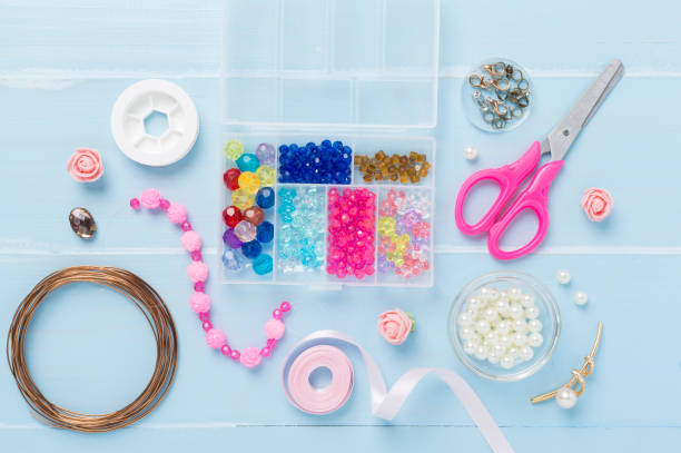 istock Tools and beads for making handmade jewelry on wooden background, top view 2205230374