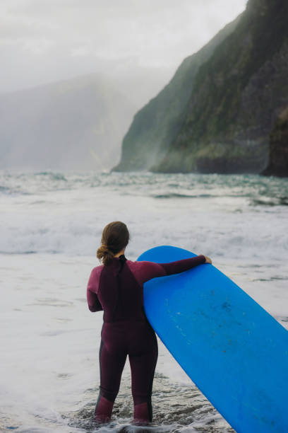 istock Active Woman Surfing at Majestic Beach with Scenic Views 2205231886