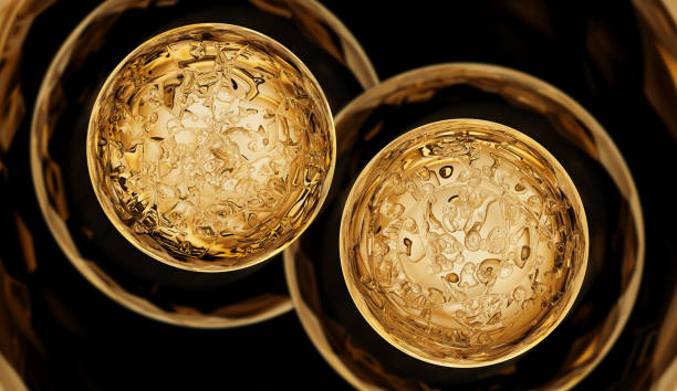 Transparent ball with golden lighting and bubbles inside. Golden glass background, yellow color and dark surroundings. Design element.