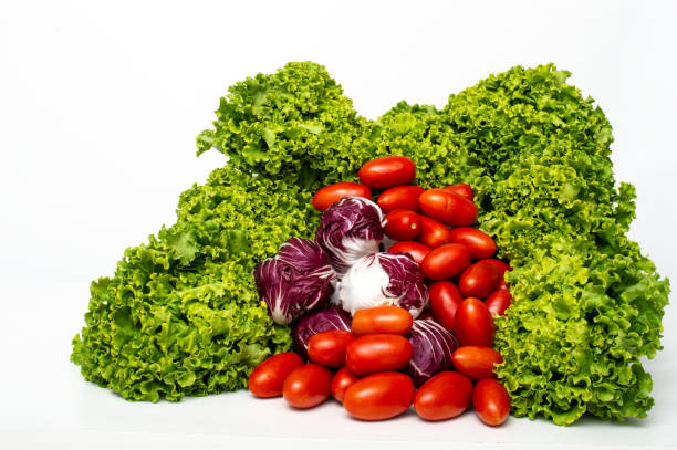 expositions of healthy vegetables  salad, lettuce, cucumber, peach, tomato. Isolated on white background