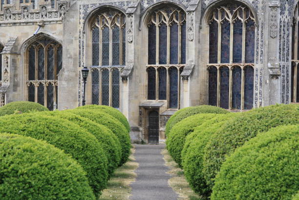 Trimmed hedge lined path leading to Lavenham Church in Suffolk