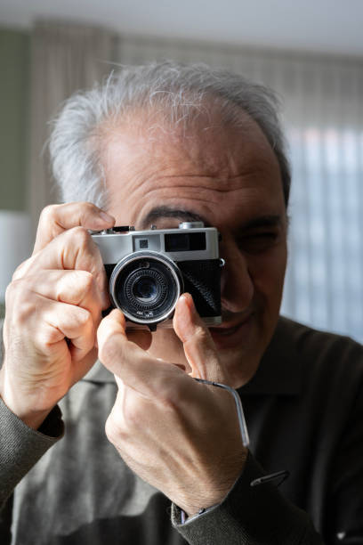 istock Senior Man Taking Pictures 2205239676
