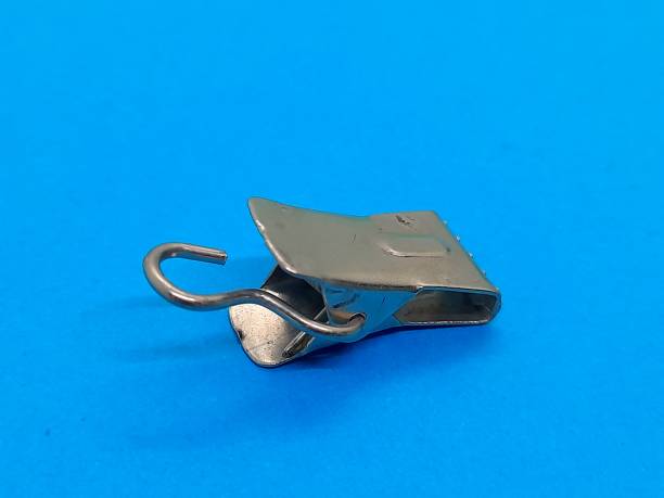 istock One metal curtain clip with blue background 2205240351