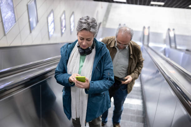 Mature couple riding on escalator