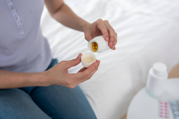 istock Wellness at Home: An Asian Woman's Medication Routine in a Stylish Bedroom 2205243666