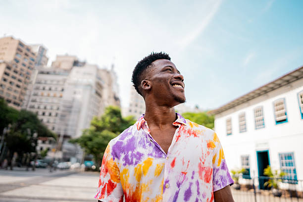 Young man walking and looking around in the street