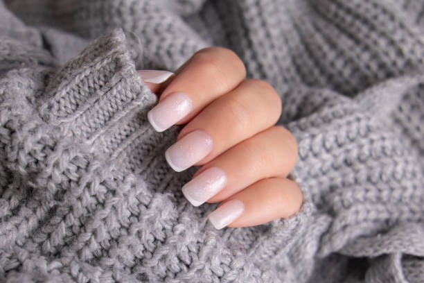 istock Female hand with french manicure nails 2205253055