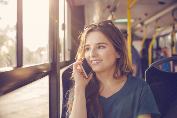 istock Woman talking on cellphone while traveling in bus 2205253079