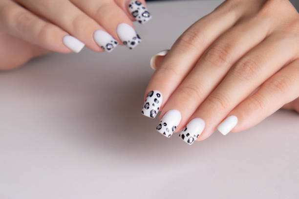 istock Female hands with white manicure nails 2205253170