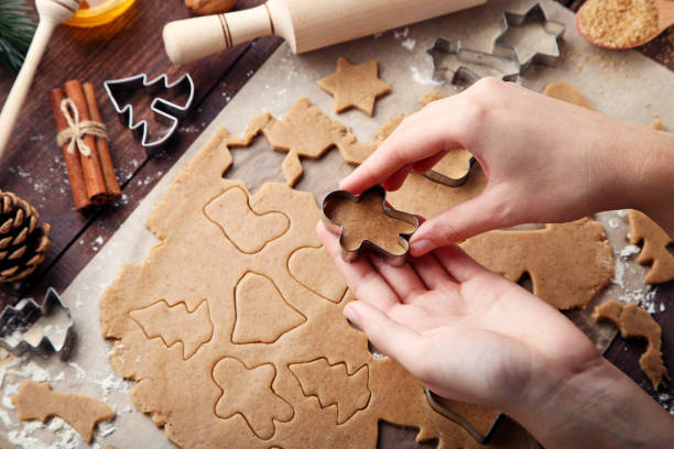 istock Baking christmas cookies on brown wooden table 2205254208