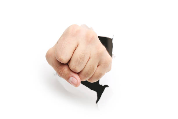 istock Male hand punching through the paper 2205256503