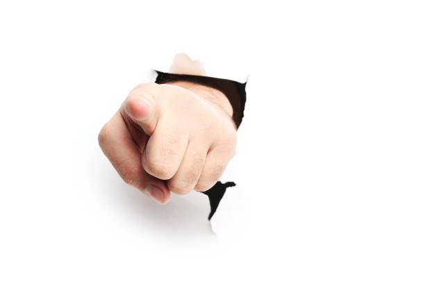 istock Male hand punching through the paper 2205256661
