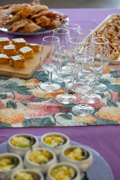 Table with desserts and fruit salad and empty crystal glasses