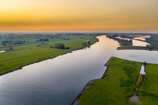istock Lowland river IJssel through sunset landscape 2205262340
