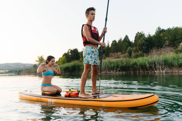 istock Summer Splash: Teenagers Enjoy Fun on a Paddleboard 2205262977