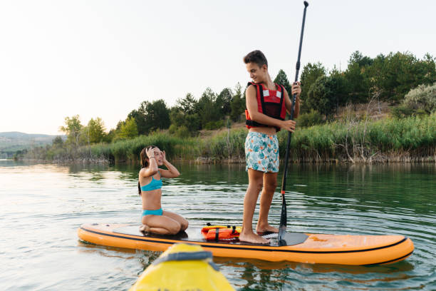istock Summer Splash: Teenagers Enjoy Fun on a Paddleboard 2205263011