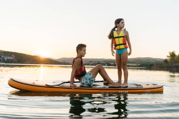 istock Summer Splash: Teenagers Enjoy Fun on a Paddleboard 2205263082