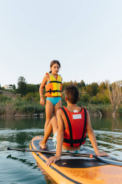 istock Summer Splash: Teenagers Enjoy Fun on a Paddleboard 2205263111