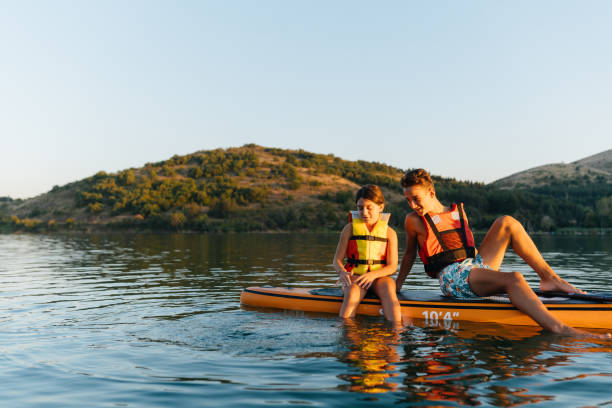 istock Summer Splash: Teenagers Enjoy Fun on a Paddleboard 2205263669