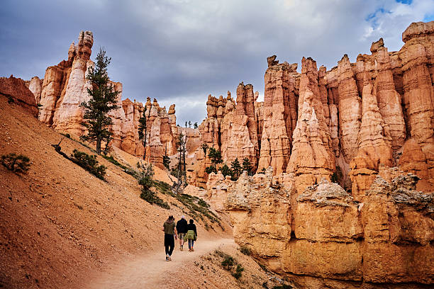 Hikers below hoodoos in canyon, distant view, Bryce Canyon, Utah