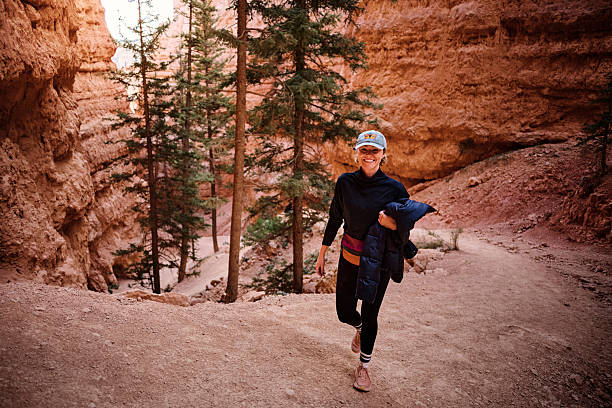 Woman hikes on canyon pathway, Bryce Canyon