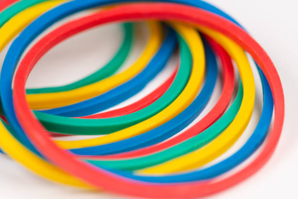 Stationery colorful rubber bands close-up on a white background.