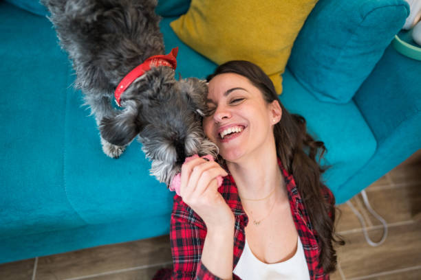 istock A woman is playing with her dog inside 2205266324