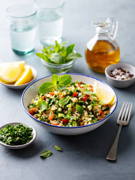 Tabbouleh salad in a bowl. Grey background. Close up.