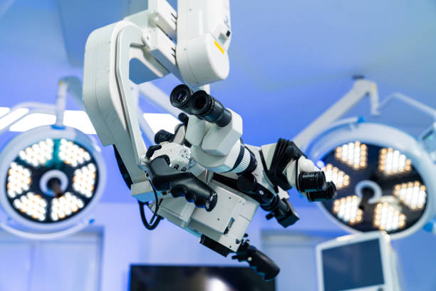 istock Microscope in neurosurgery. High-tech surgical microscope in an operating room for a neurosurgery procedure, under bright surgical lights. 2205276809