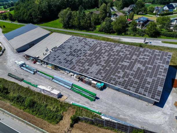 istock AERIAL: Large industrial building with damaged solar panels covering its roof 2205282488