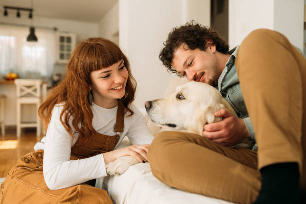 istock Joyful Moments: A Happy Couple Bonding with Their Dog at Home 2205282948