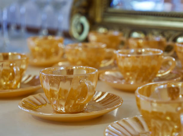 istock Amber glass teacups on saucers 2205284124