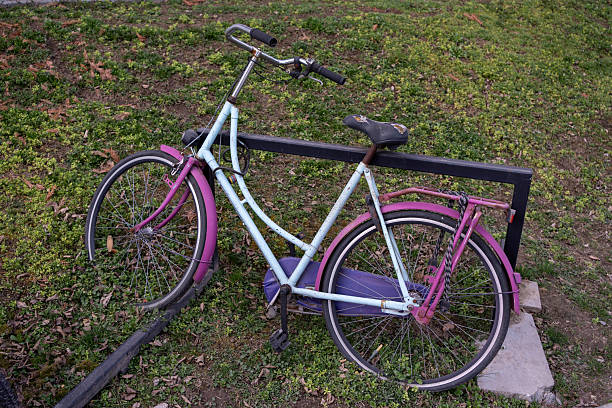 istock Light Blue Bicycle with Purple Accents Leaning Against Metal Structure 2205286184