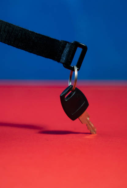 istock Flat Lay Black Keychain with Key on Red and Blue Background 2205286242