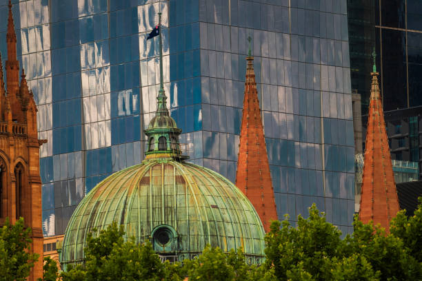 A view of the Flinders Street station from above set against a background of modern glass buildings.