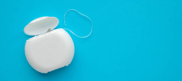 istock dental floss in case on blue background 2205293035