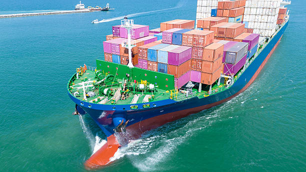 istock Aerial side view of cargo ship carrying container and running for export goods from cargo yard port to custom ocean concept technology transportation 2205294327