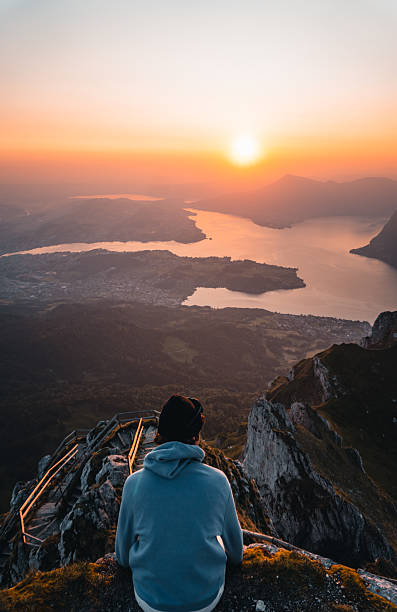 istock Hiker on pathway above lakes and mountains at sunset 2205294913