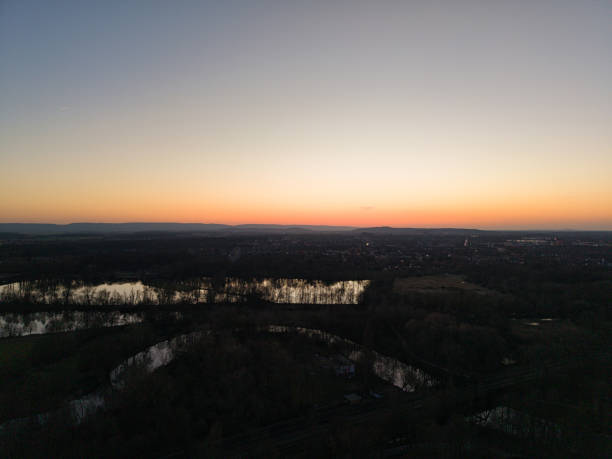 A captivating and breathtaking view of a sunset beautifully casting vivid hues over rivers and lush greenery Maschsee Hannover