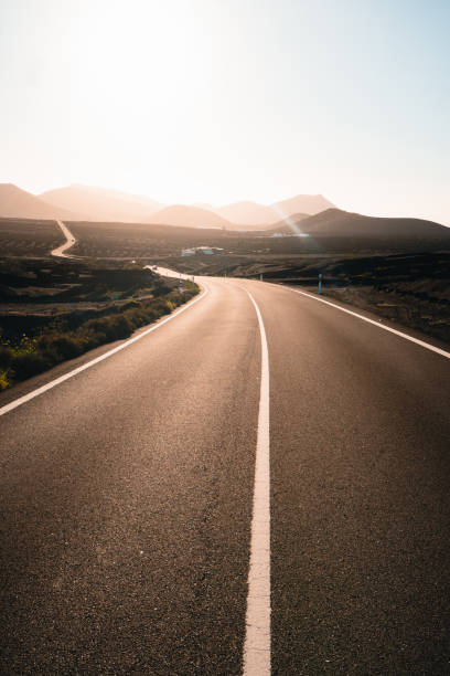 istock Close-up looking down road at sunrise 2205299087