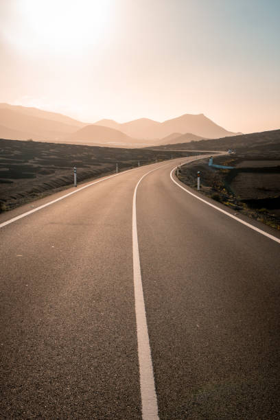 istock Close-up looking down road at sunrise 2205299088