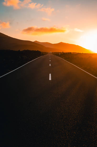 istock Close-up looking down road at sunrise 2205299168