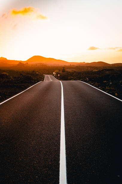 istock Close-up looking down road at sunrise 2205299178