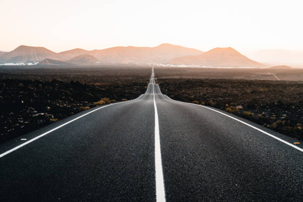istock Close-up looking down road at sunrise 2205299179