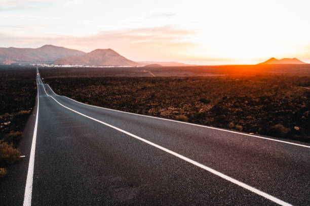 istock Close-up looking down road at sunrise 2205299258