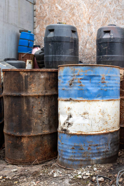 istock Rusty Barrels and Containers in Industrial Storage Area 2205300935