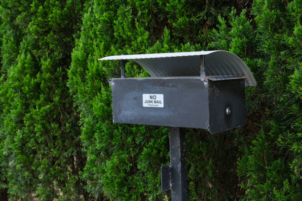 White and weathered letterbox with number 18 in the front yard of a Sydney home in Australia