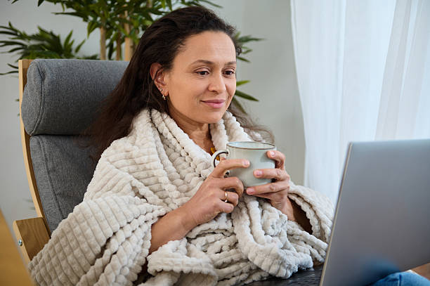 Cozy Work from Home Setup with Woman Enjoying a Beverage