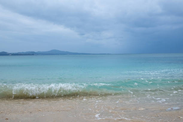 Waves crashing on Okinawa's coral sand beach